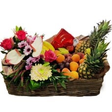 Basket Filled With Flowers, Fruits And Chocolate