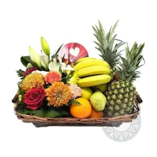 Basket filled with flowers, fruits and chocolate