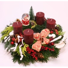 Advent wreath with burgundy candles and snowy branches