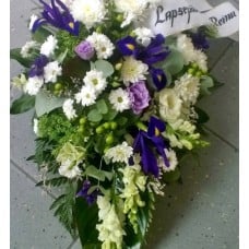 Funeral arrangement of white and purple flowers