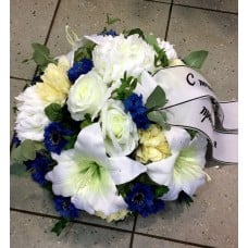 Round-shaped funeral arrangement with artificial flowers
