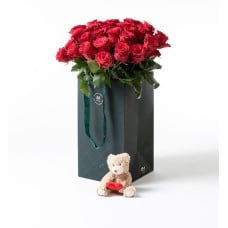 30 red roses in a gift bag with teddy bear