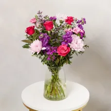 An eclectic bouquet of purple and pink flowers