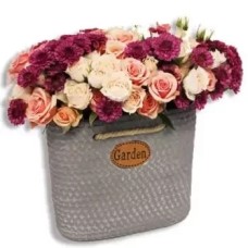 Mix of pastel coloured flowers in a pot