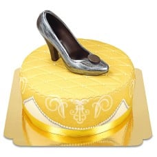 Golden deluxe cake with chocolate shoe and ribbon