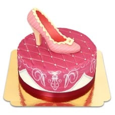 Pink deluxe cake with chocolate shoe and ribbon