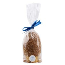 Dark chocolate egg with praline flakes, garnished with eggs, fried goods and praline flakes
