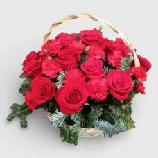 arrangement of roses and carnations in a basket