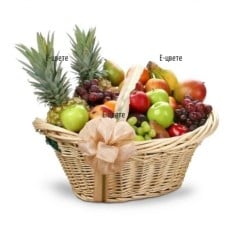 Basket with fruits and two pineapples