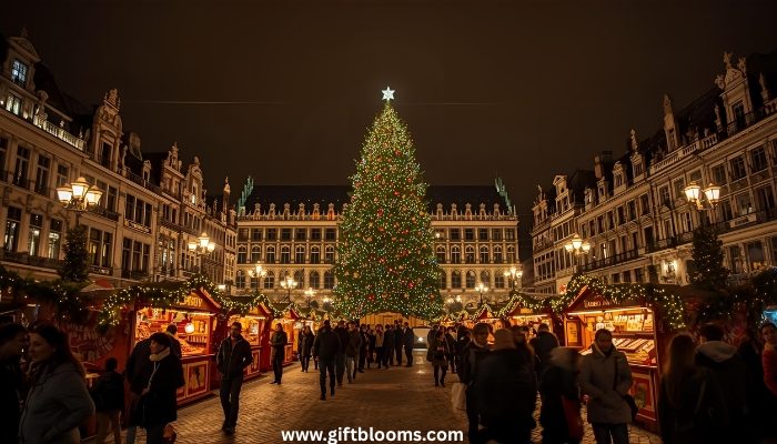 Brussels Winter Wonders Christmas market illuminated at night showing Grand Place Christmas tree, festive stalls, and crowds of holiday shoppers