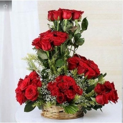 A Round Basket Arrangment Of 50 Red Roses (As Shown)