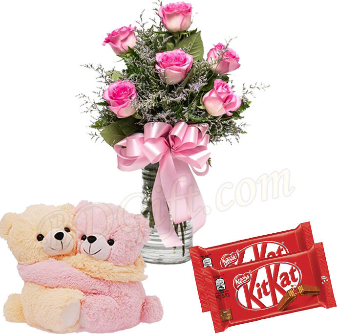 Pink roses with chocolate and candle