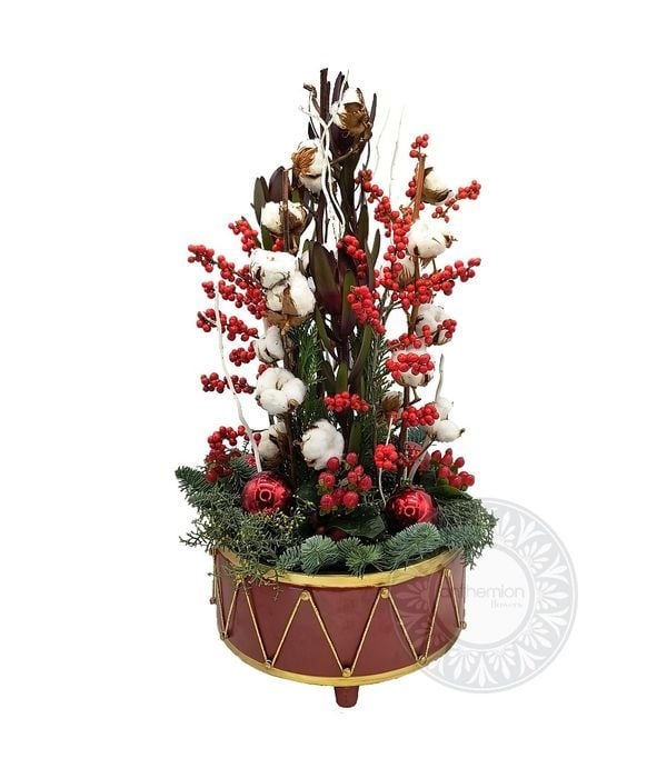 Festive flower arrangement in a metallic drum