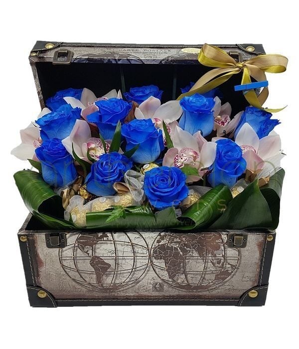 Blue roses,orchids and chocolates in a chest