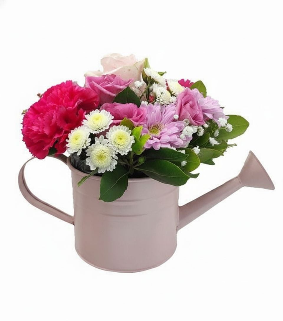 Fuchsia and pink flowers in watering can