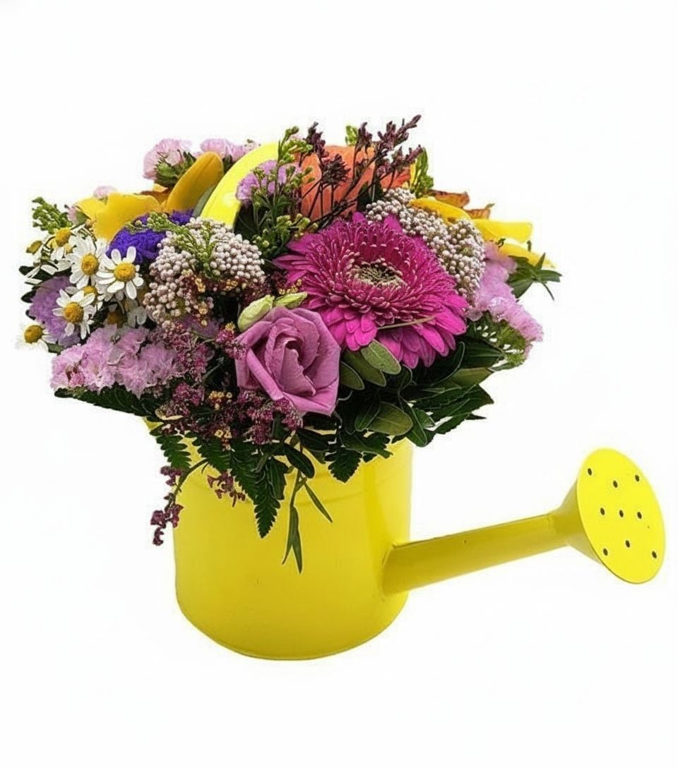 Yellow watering can with fresh flowers
