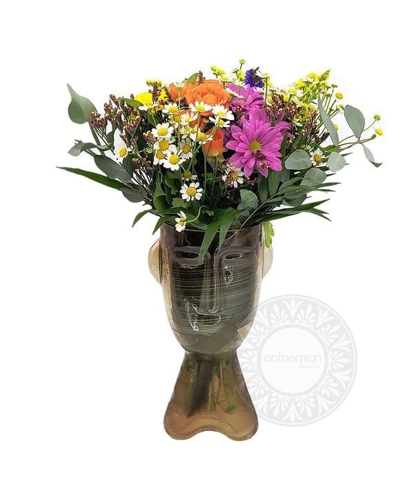 Happy flowers in a glass head
