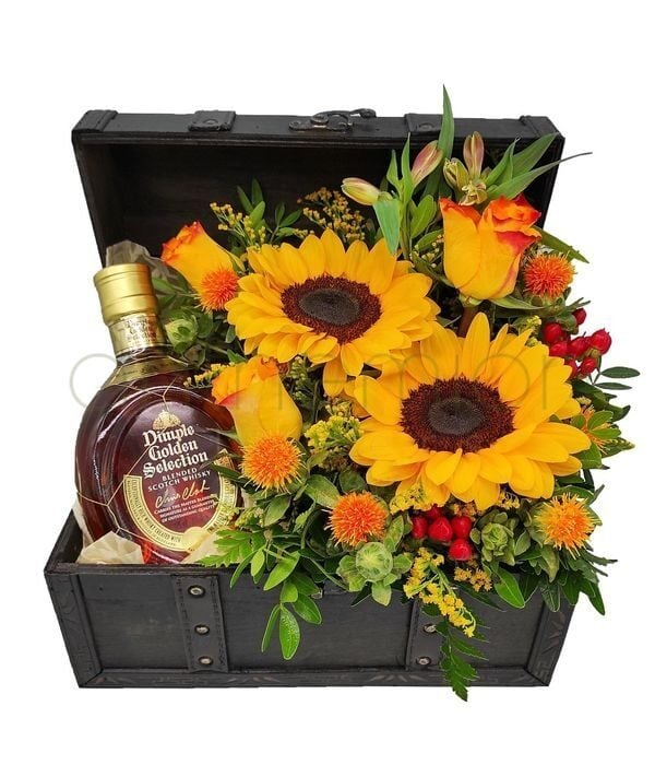 Dimple and yellow|orange flowers in a wooden chest