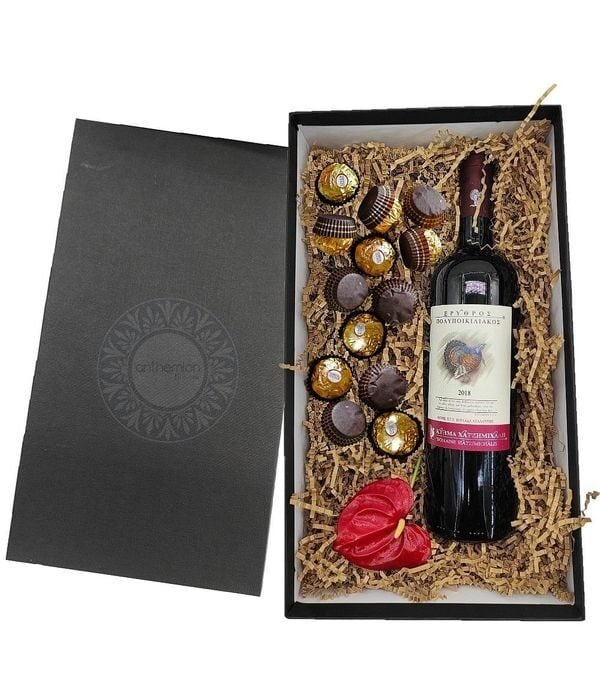Gift box with red wine and chocolates