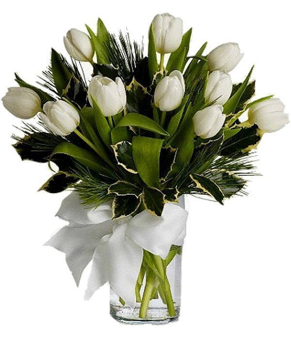 Ten white tulips in a glass vase