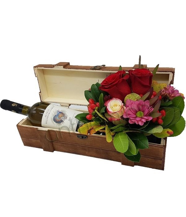 Wooden box with flowers and wine