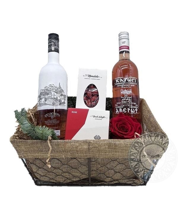 Basket with rosÃ© wines and sweet treats