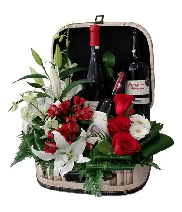 Leather suitcase with flowers and wine