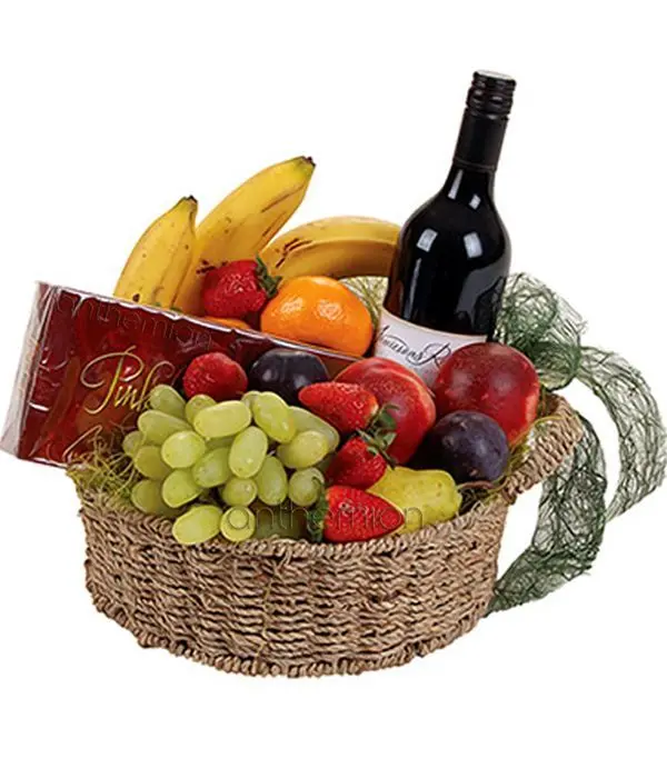 Basket with fruits, wine and chocolates