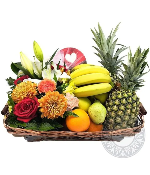 Basket filled with flowers, fruits and chocolate