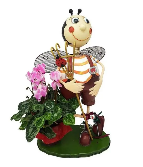 Metallic base with pink cyclamen plant
