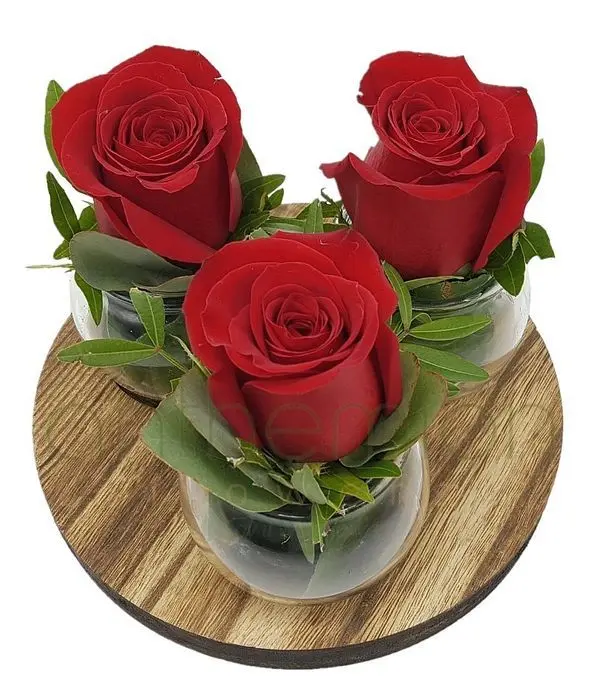 Red floral arrangement on wooden base