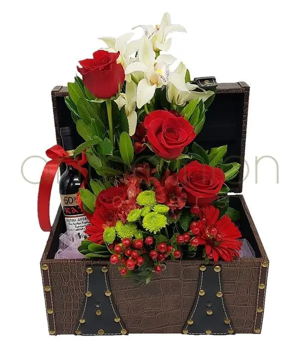 Chest with one bottle of wine and flowers