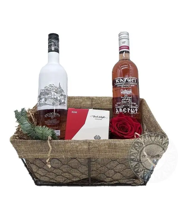 Basket with rosé wines and sweet treats