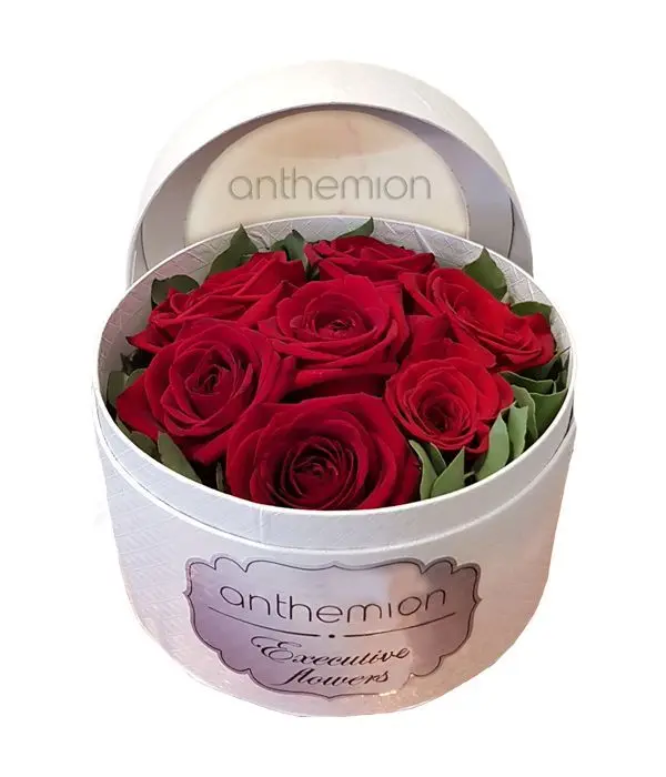 Arrangement of red roses in round white box
