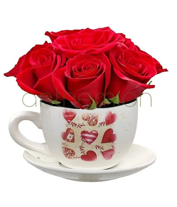 Rose arrangement in a cup