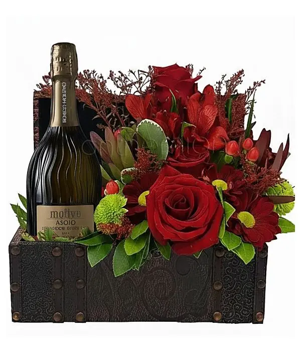 Chest with a bottle of sparkling wine and flowers