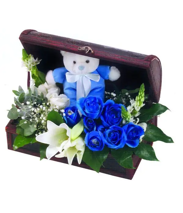 Blue roses in chest with teddy bear
