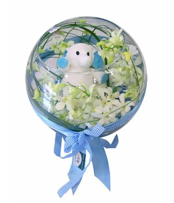 Glass ball with orchids and blue teddy bear