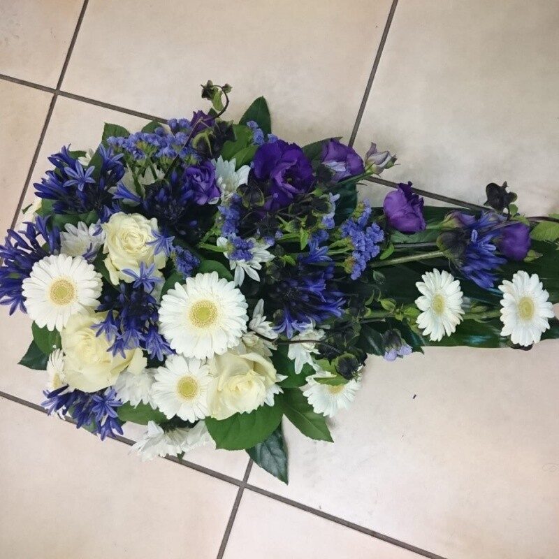 Funeral arrangement with white and purple