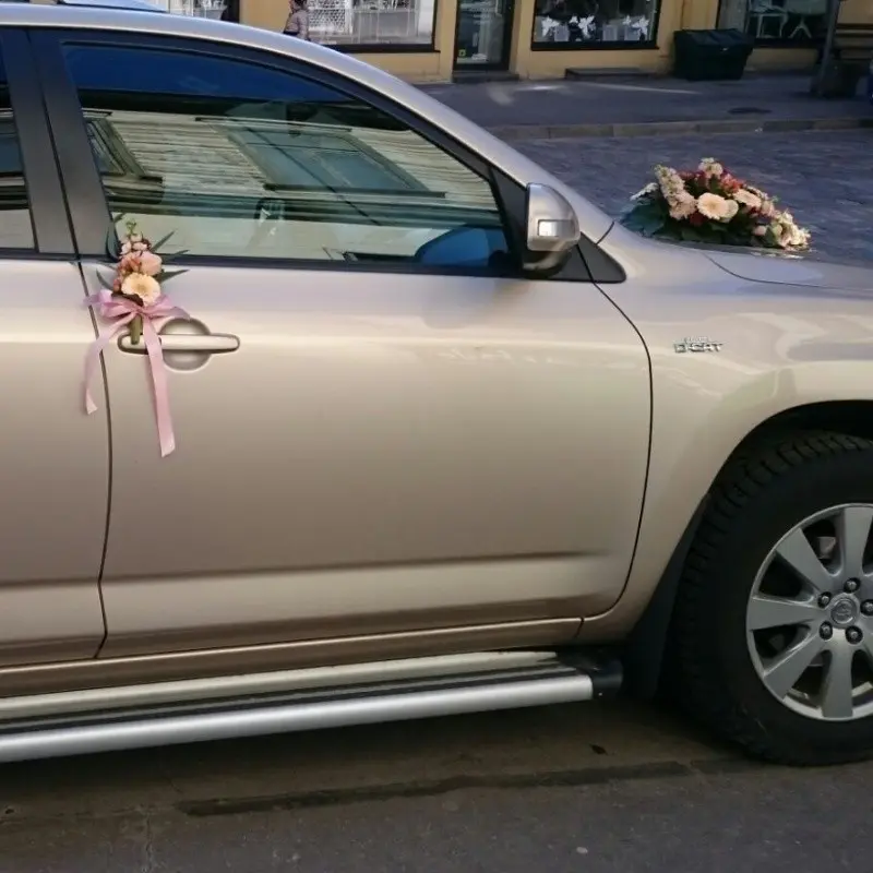 Wedding car decor with pink ribbon