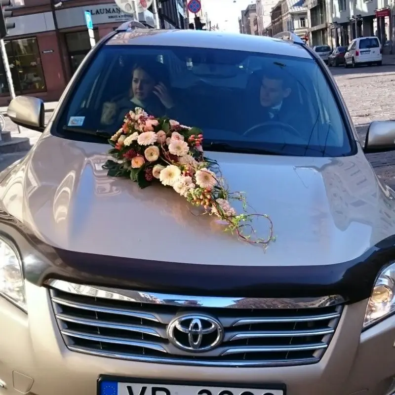 Wedding car decor with light colour flowers