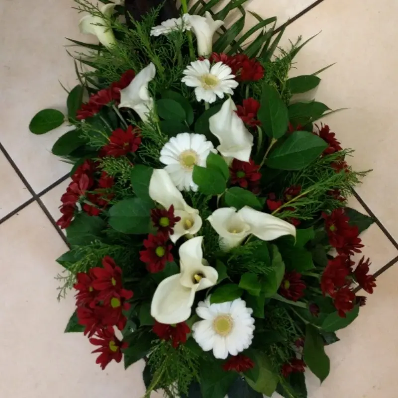 Funeral arrangement with red and white flowers