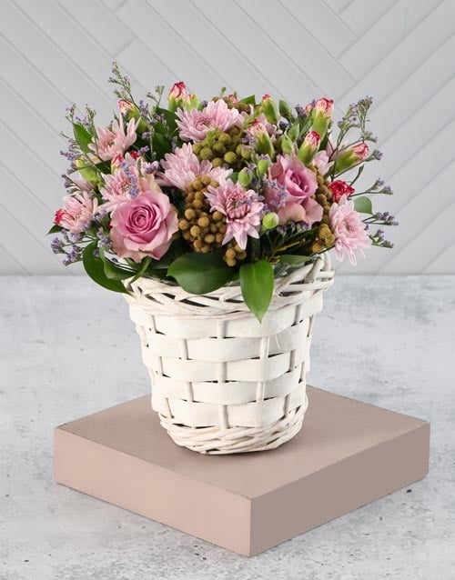 Pink And Purple Blooms In A White Basket
