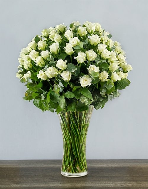100 White Roses In A Tall Glass Vase
