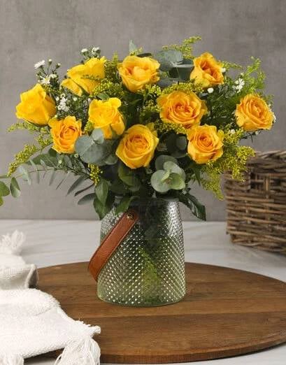 Yellow Roses In A Leather Handle Vase