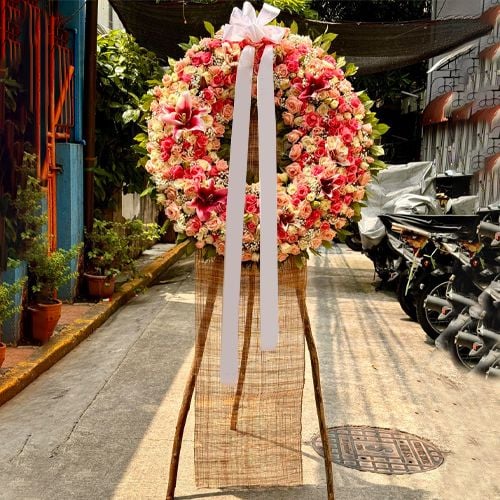 Roses with Lilies and Seasonal Flowers Wreath
