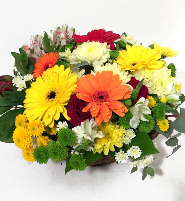 Flower arrangement with a basket of gerberate, ancillary flowers and grapes (Classic)