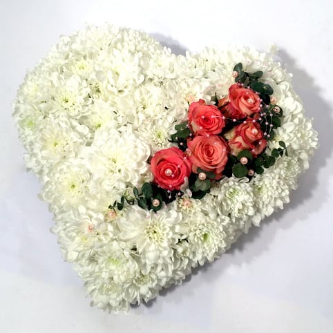White heart-shaped arrangement of chrysantemums