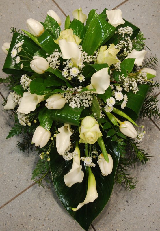 Funeral arrangement of white callas and tulle
