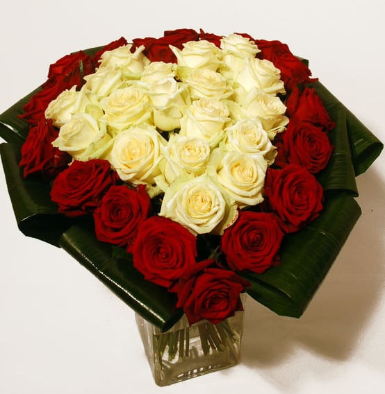 Heart-shaped bouquet of red and white roses